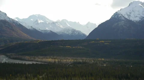 Pan Left, Snow-capped Mountains, Rocky Bluff, Autumn Trees, Glacier Stock Footage 38104927