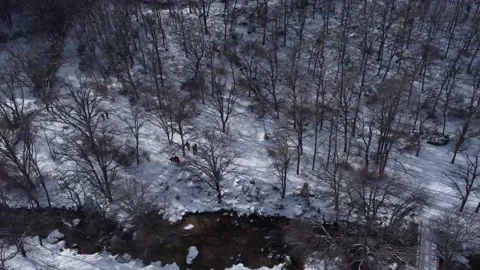 Pan left of snow mountain trees and people walking from above Stock Footage 158547579