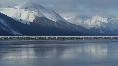 Pan Left Snowy Mountains, Reflected in Water Stock Footage 38074887