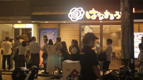 Pan Left Street View of Busy Ramen Restaurant at Night in Osaka, Japan Stock Footage 337909655