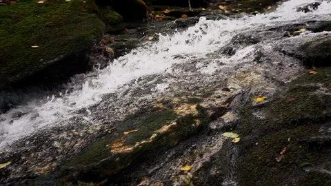 Pan Left Track Down Water Flowing Down Natural Waterfall in Mountains  Stock Footage 96720625