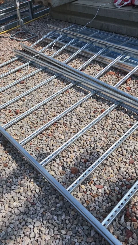 Pan left video of empty galvanized metal cable tray ladder on gravel. Stock Footage 338175278