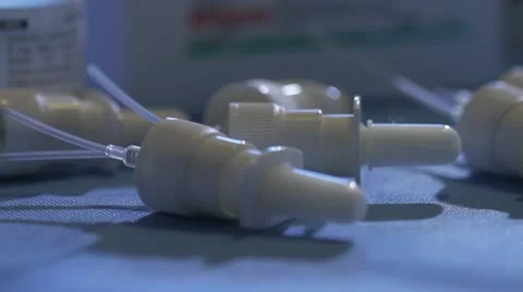 Pan from lid to bottle top to opening needle package in lab Stock Footage 20447247