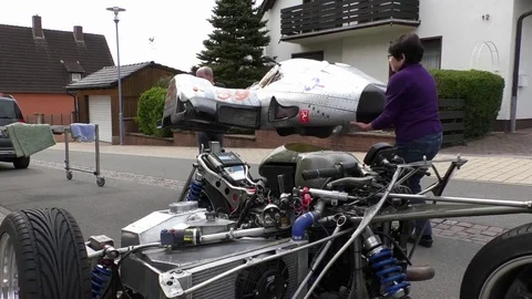 Pan: Lifting the bodywork of a sidecar machine, racing motorbike and sidecar Stock Footage 76769168