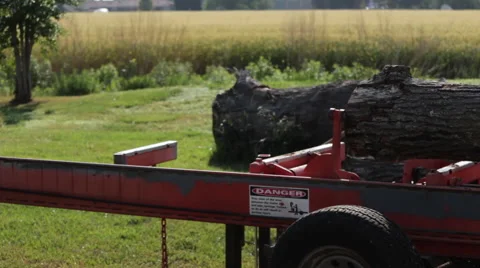Pan of log on portable sawmill rails Stock Footage 40472244