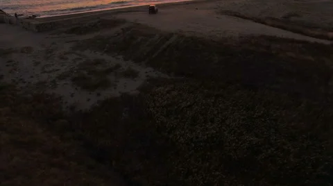 Pan looking over a cliff at the sea at sunrise 스톡 동영상 68919205