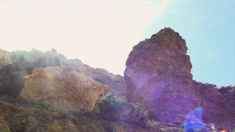 Pan low angle on rock in backlight Video stock 83043836