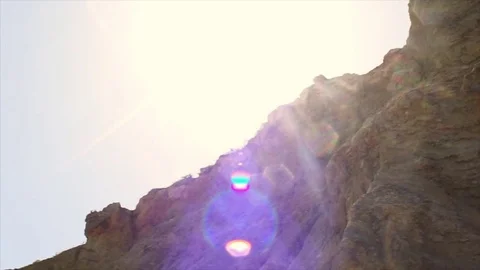 Pan low angle on rock in backlight Video stock 83043906