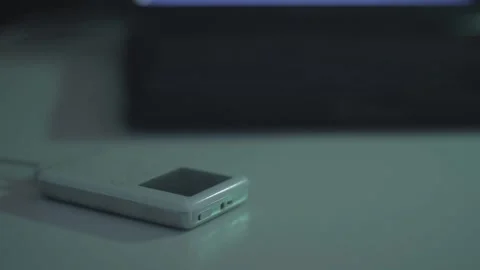 Pan from Macintosh Powerbook G3 to 3rd generation iPod Stock Footage 152608755