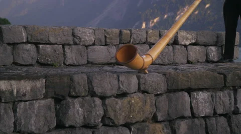Pan of man playing alphorn Stock Footage 52233601
