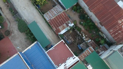 Pan Up Man Sitting on a Wall in Rural Village Vietnam Aerial Drone Shot Stock Footage 122239532