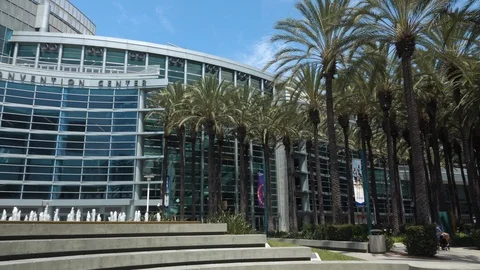 Pan from man with stroller to convention center Stock Footage 112945755