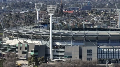Pan of MCG looking down and across with suburban background Melbourne Stock Footage 228176939