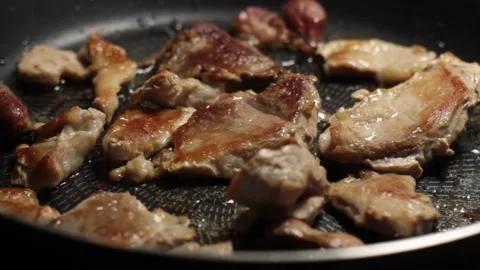 The pan with meat rotates counterclockwise Stock Footage 133250176