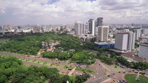 Pan of Merdeka Square and skyscrapers in Jakarta centre Stock Footage 79062106