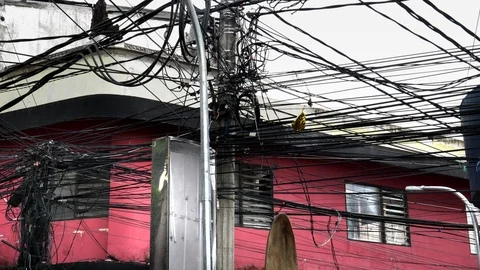 Pan of messy power lines at kuta in bali Stock Footage 88758992