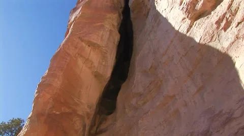 Pan up mountain to cave Stock Footage 61575387