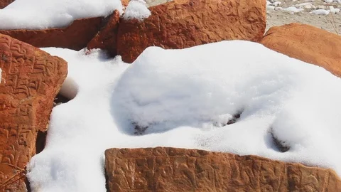 Pan movement looking at rick bricks and tiles with Nepalese script writing Stock Footage 105546696