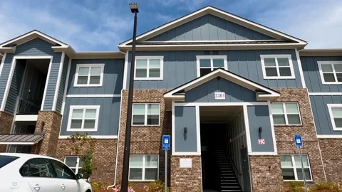 Pan of new  Apartment complex buildings street pan brick and panel style Stock Footage 180234621