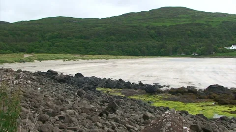 Pan on North Atlantic beach, in small sea loch Stock Footage 39859701