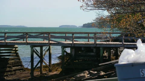 Pan from ocean dock to spill kit in Maine in summer Stock Footage 144444660