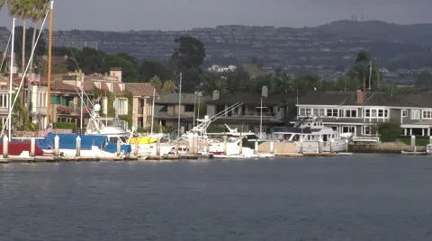 Pan of ocean front homes in late afternoon sun udner cloudy skies background Video stock 67465772