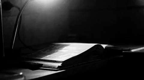 Pan out of book, lighting Stock Footage 34637298