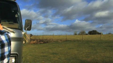 Pan out on boys reading map on van Video stock 543602