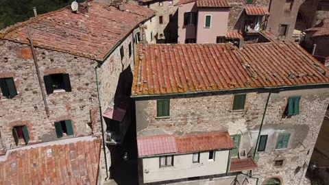 A pan out drone shot of a set of houses in a Spanish town Stockbeeldmateriaal 308413852