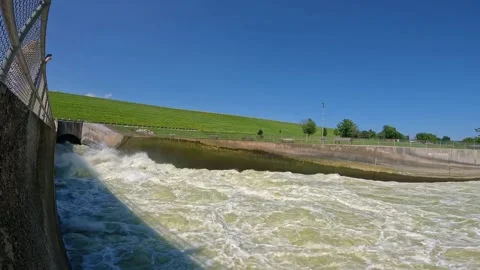 Pan of the outflow conduit pipe of the Saylorville Dam and Des Moines Stock Footage 284063121