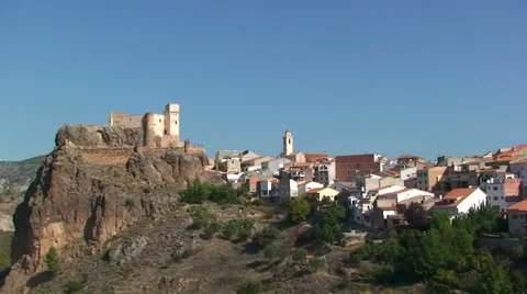 Pan over castle on the hill overseeing river and valley Stock Footage 50056997
