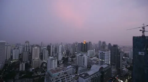 Pan over City Skyline during a purple sunset Stock Footage