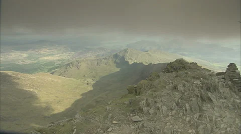 Pan over dramatic mountainside of Mount Snowdon, with sunshine, Snowdonia Wales Stock Footage 37178897
