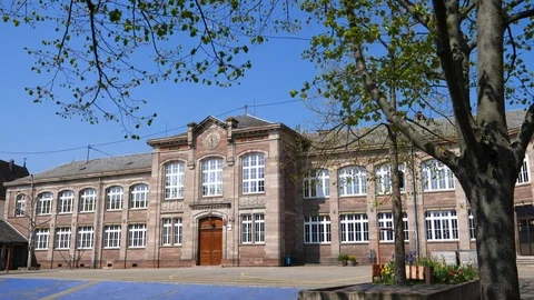Pan over the empty yard of High School Elementary School Du Centre Ecole Stock Footage 124390431