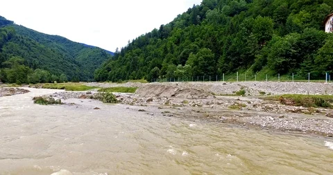 Pan over flowing river after rainfall Stock Footage 103139737