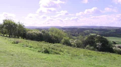 Pan over green fields and hills Stock Footage 38541473