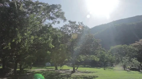 Pan Over Mountain Camp with Sun Flare at Serra do Cipo, Brazil 스톡 동영상 71478233