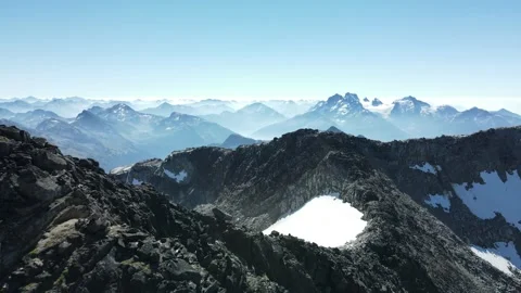 Pan over mountain ridge with pocket of snow, drone shot Stock Footage 289575345