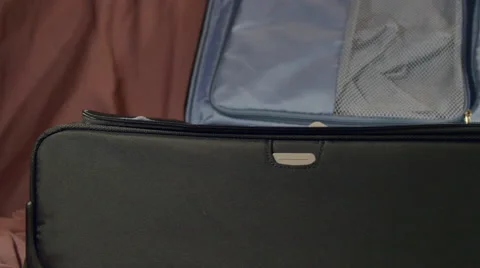 Pan Over An Open Suitcase Waiting To Be Used, Preparing For Journey Stock Footage 64763346