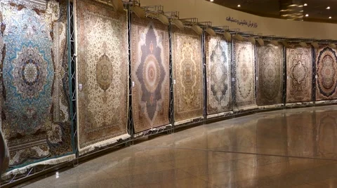 A pan over Persian handmade carpets with spotlight on the rugs. Video stock 66543044