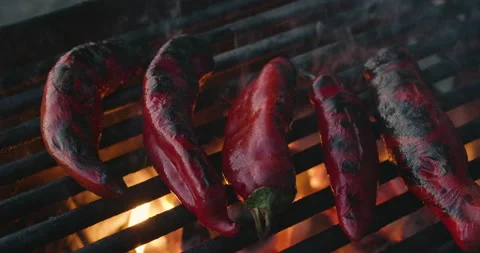 Pan Over Red Chiles Roasting on a Grill Stock Footage 144778722