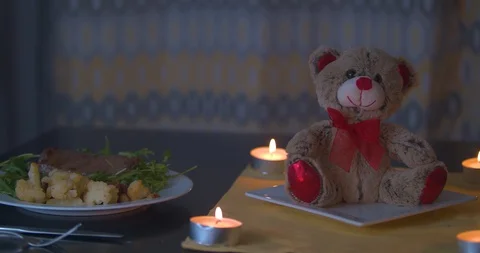 Pan over a Romantic Dinner Lit by Candles Stock Footage 101374676