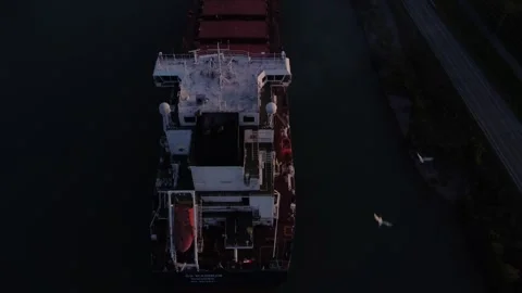 Pan up over ship in the locks at sunset Stock Footage 255403887
