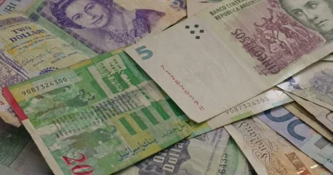 Pan over stacks of different currency Stock Footage 293608558