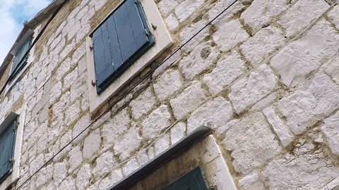 Pan over stone wall of old town house Stock Footage 123013092