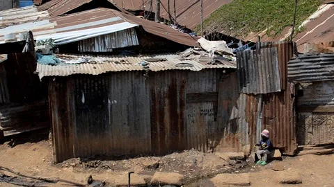 Pan over tin-roofed shacks in Kibera Slum, Nairobi, Kenya Video stock 100051538