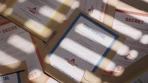 Pan over various color coded classified top secret documents and folders Stock Footage 221229842
