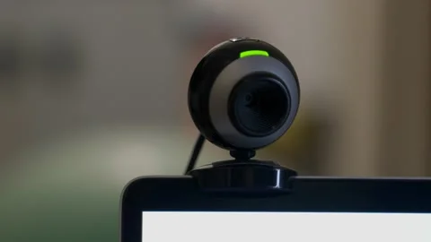 Pan over webcam on a computer screen or laptop with green light that turns off Video stock 158551414