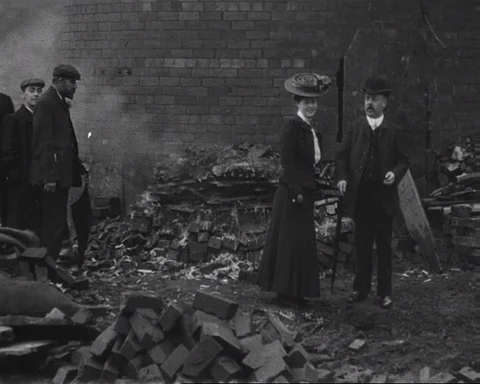Pan of passer-by people observing chimney after explosion, UK 1906 Stock Footage 136820804