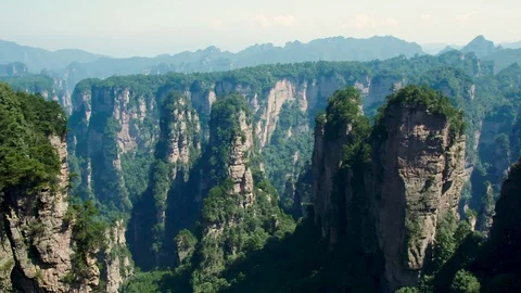Pan of Pillars in Forest Mountain Area in China Stock Footage 120527002